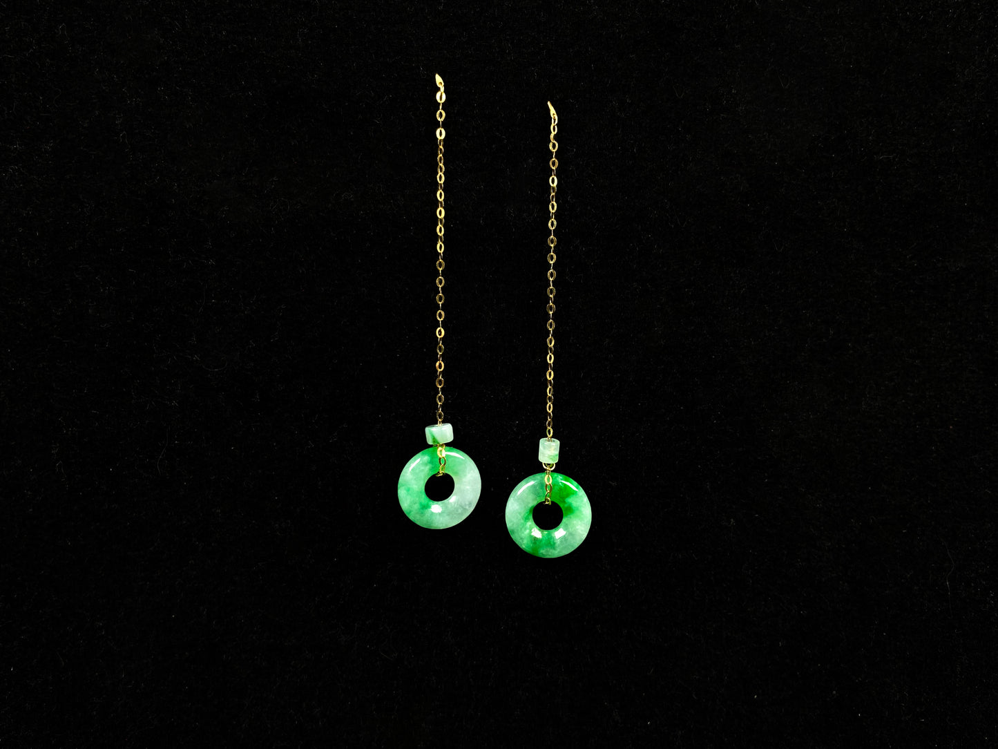 A green dew donut and cylinder jadeite earring.