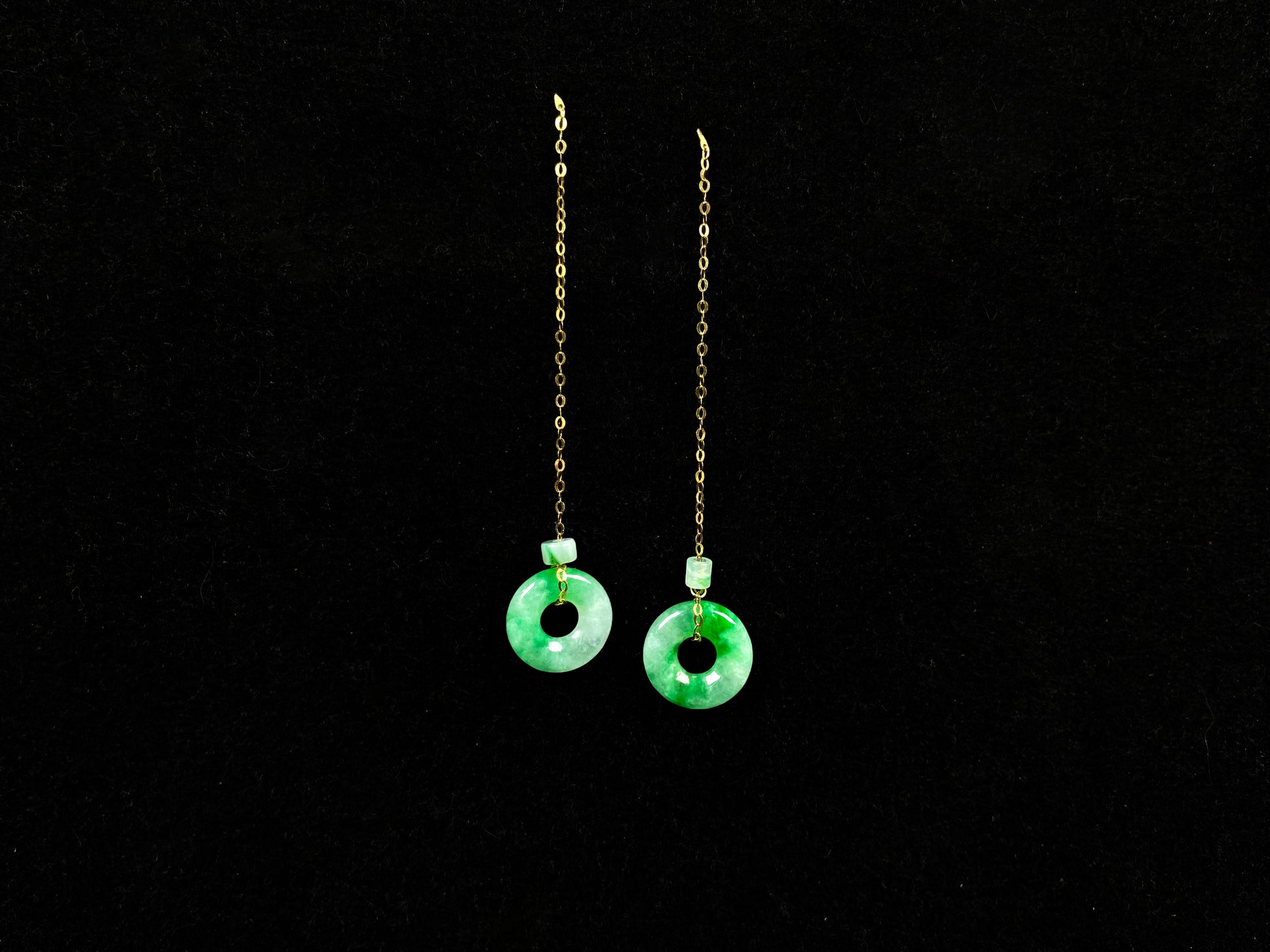 A green dew donut and cylinder jadeite earring.