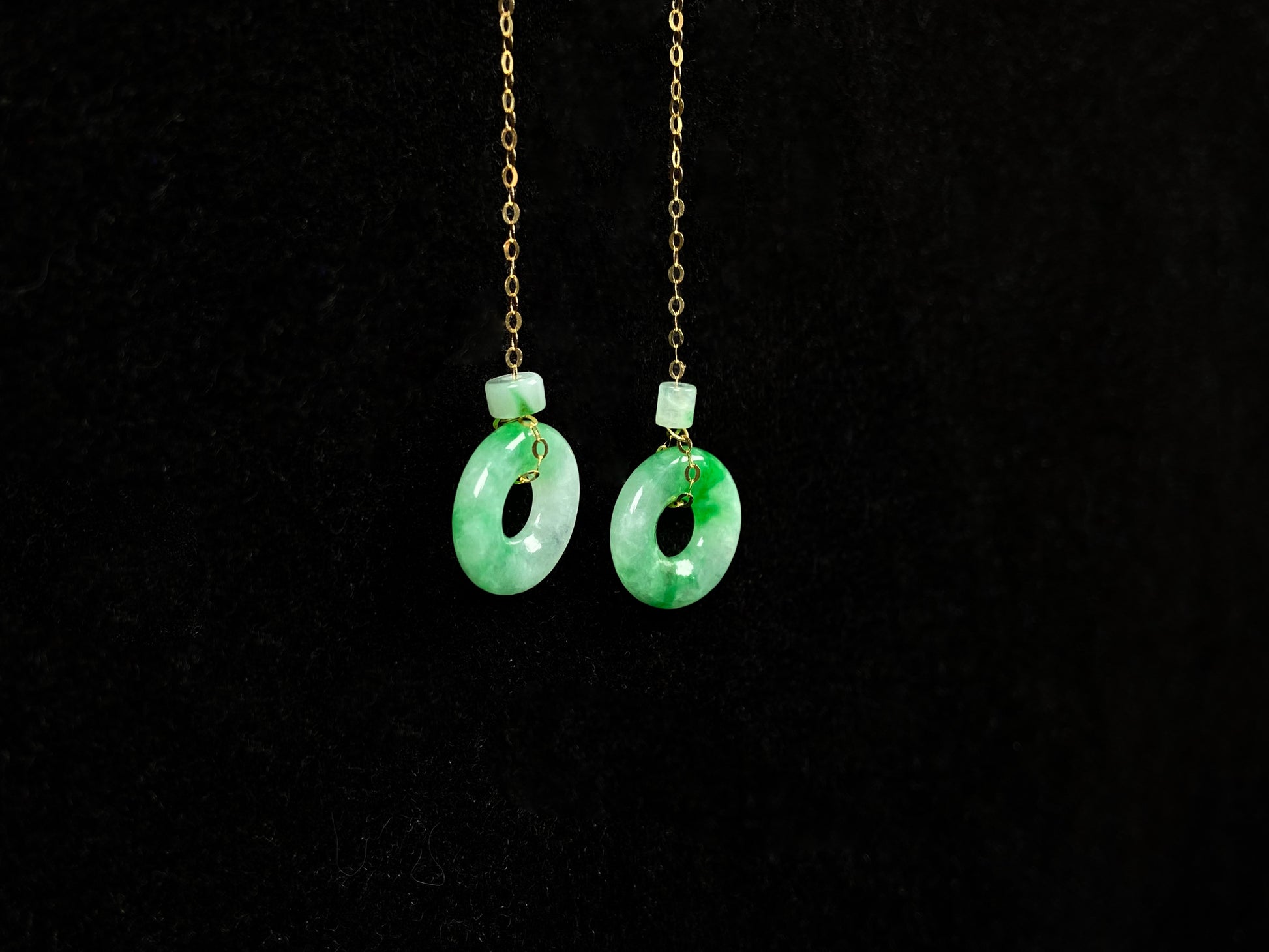 A green dew donut and cylinder jadeite earring.