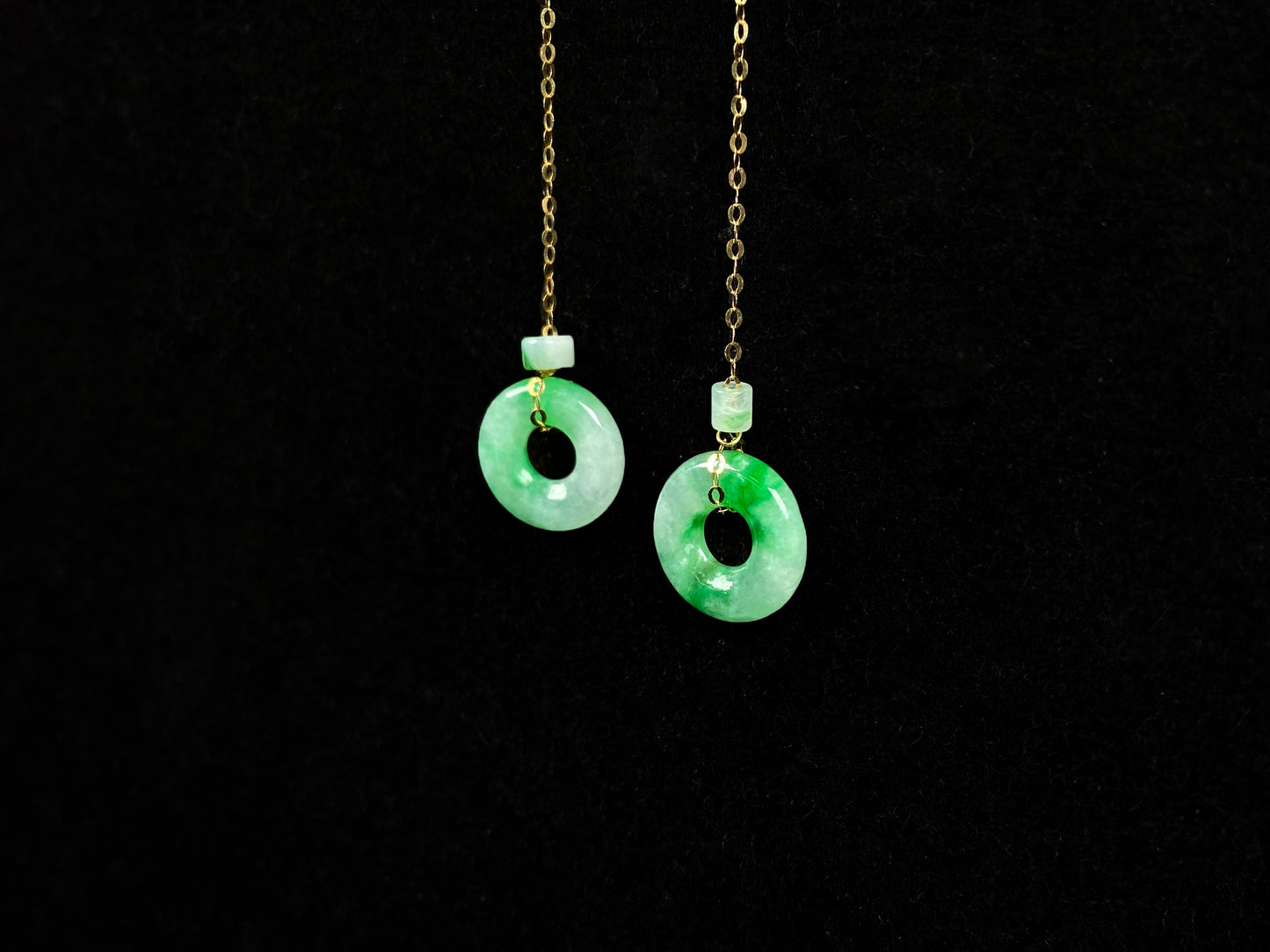 A green dew donut and cylinder jadeite earring.