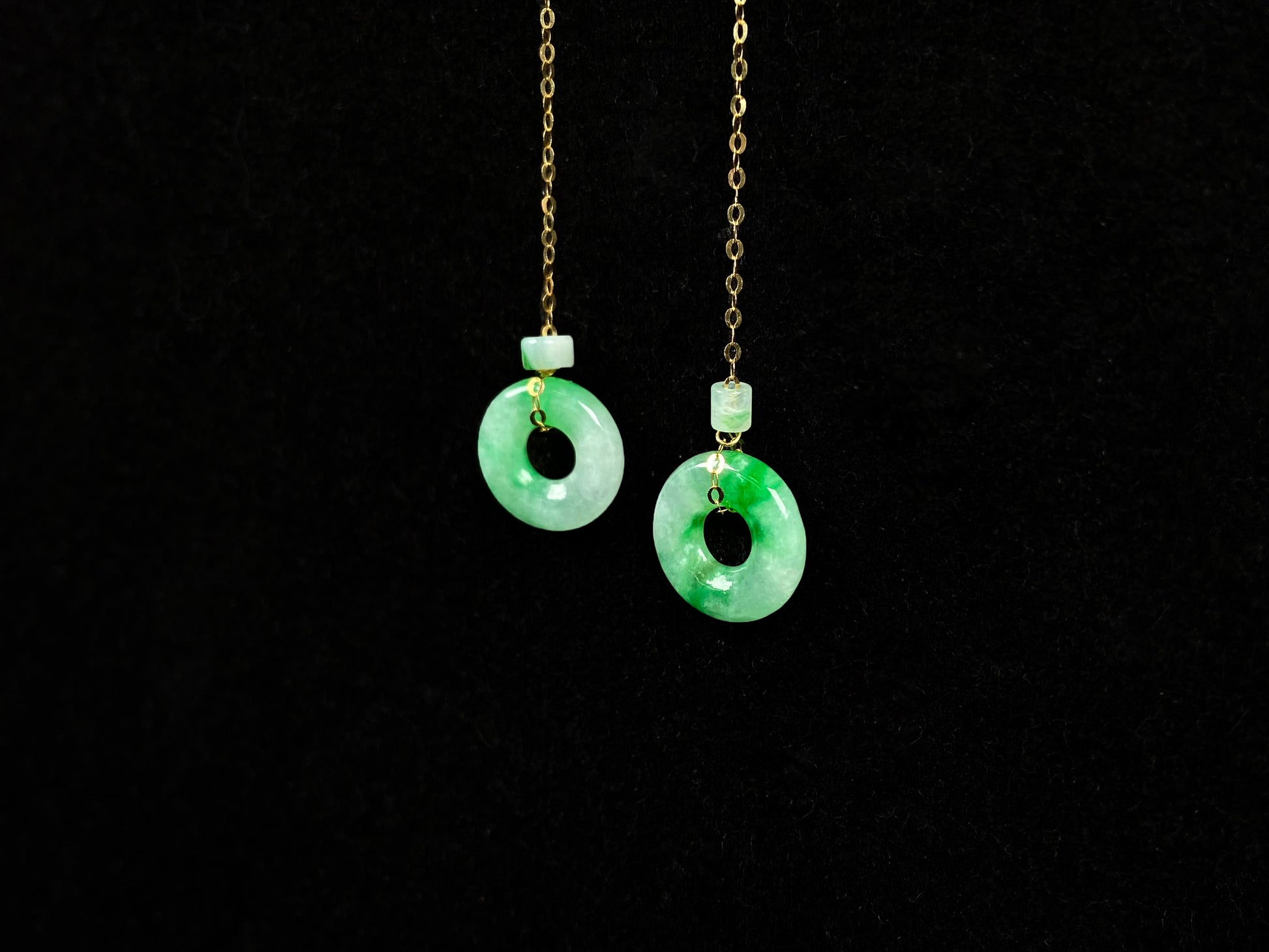 A green dew donut and cylinder jadeite earring.
