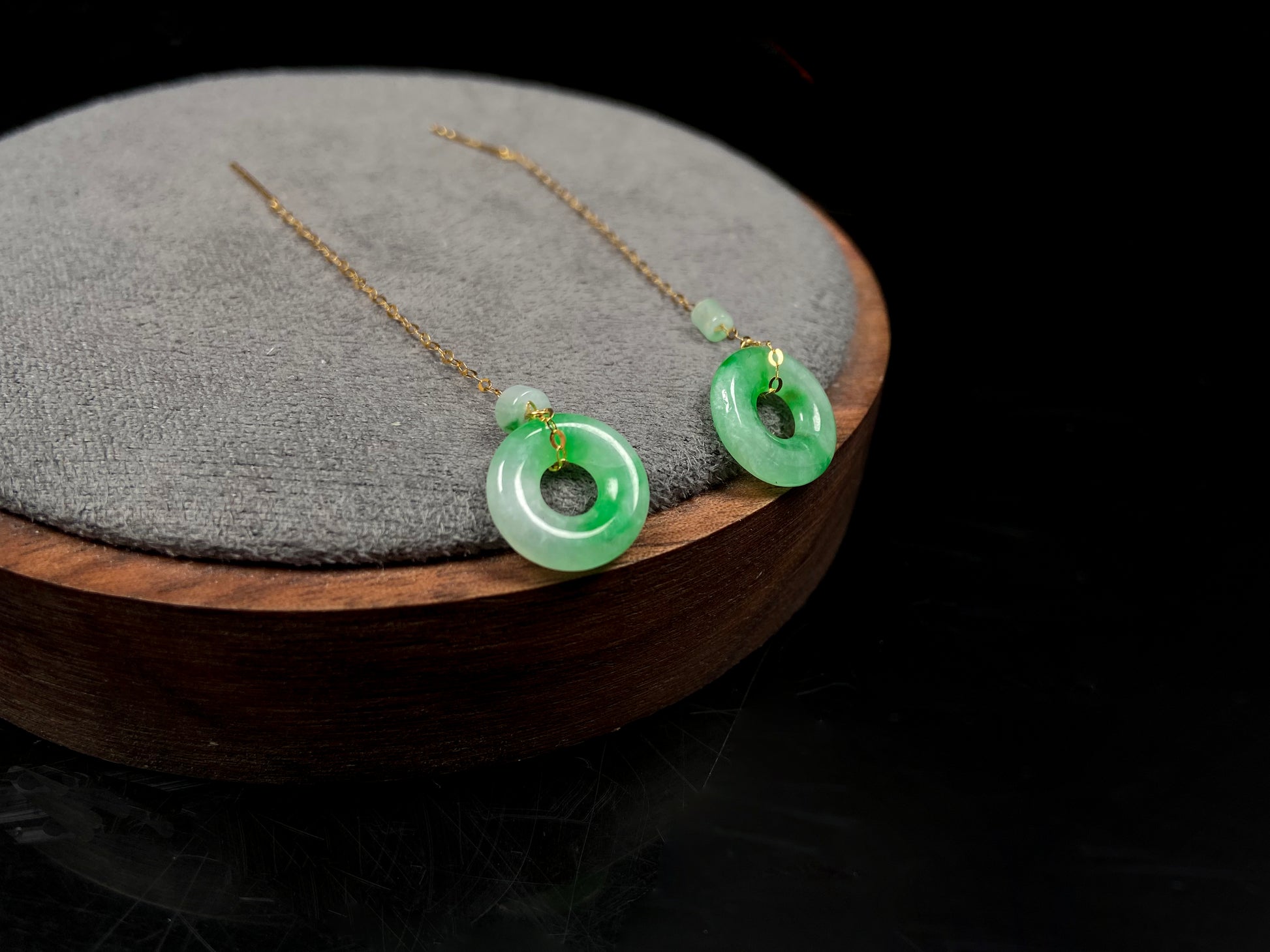 A green dew donut and cylinder jadeite earring.