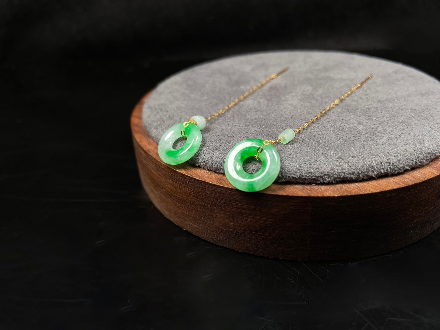 A green dew donut and cylinder jadeite earring.