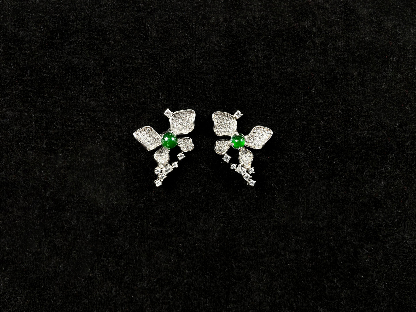 A pair of sparkling petal green core jadeite earrings.