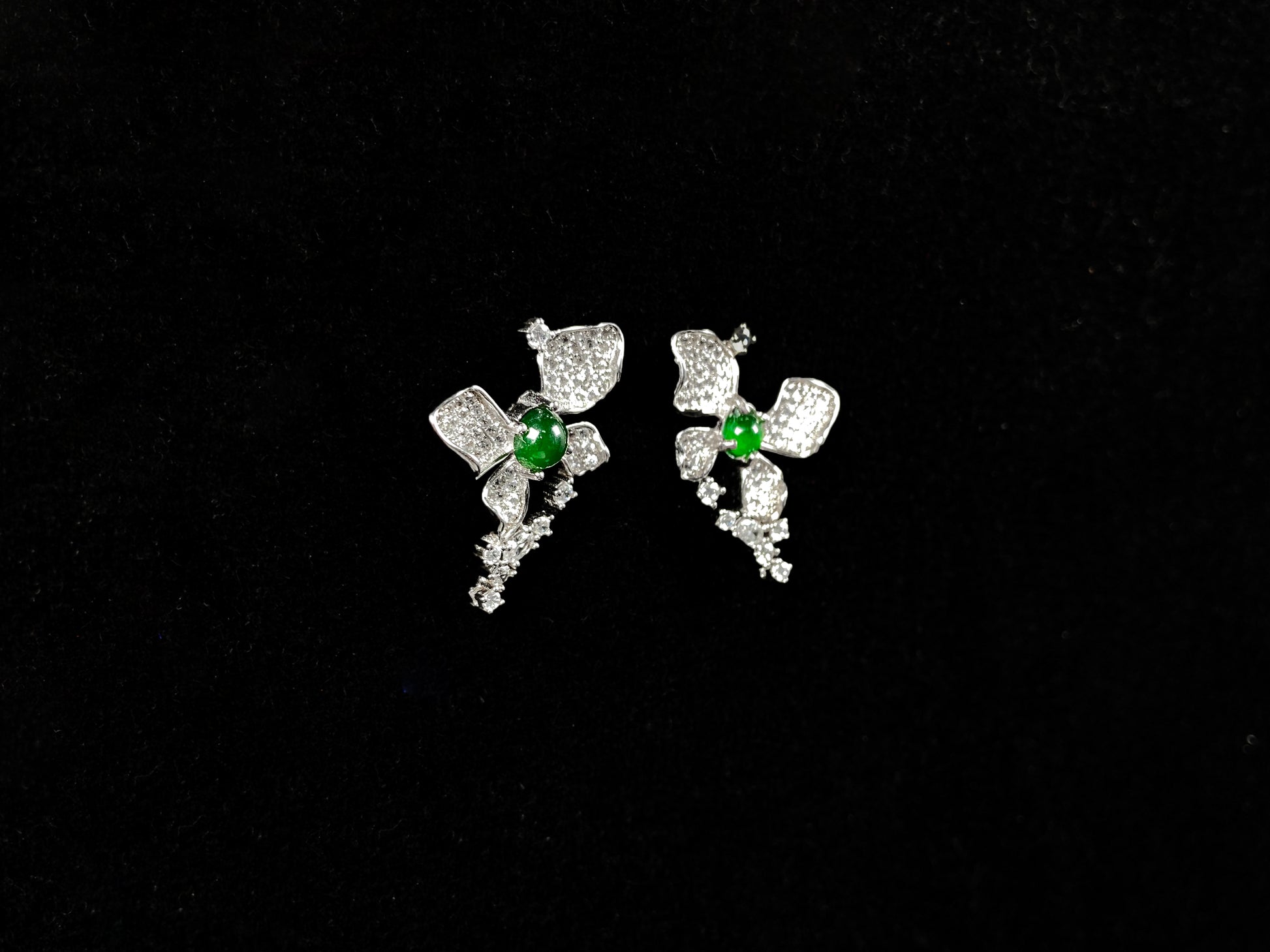 A pair of sparkling petal green core jadeite earrings.
