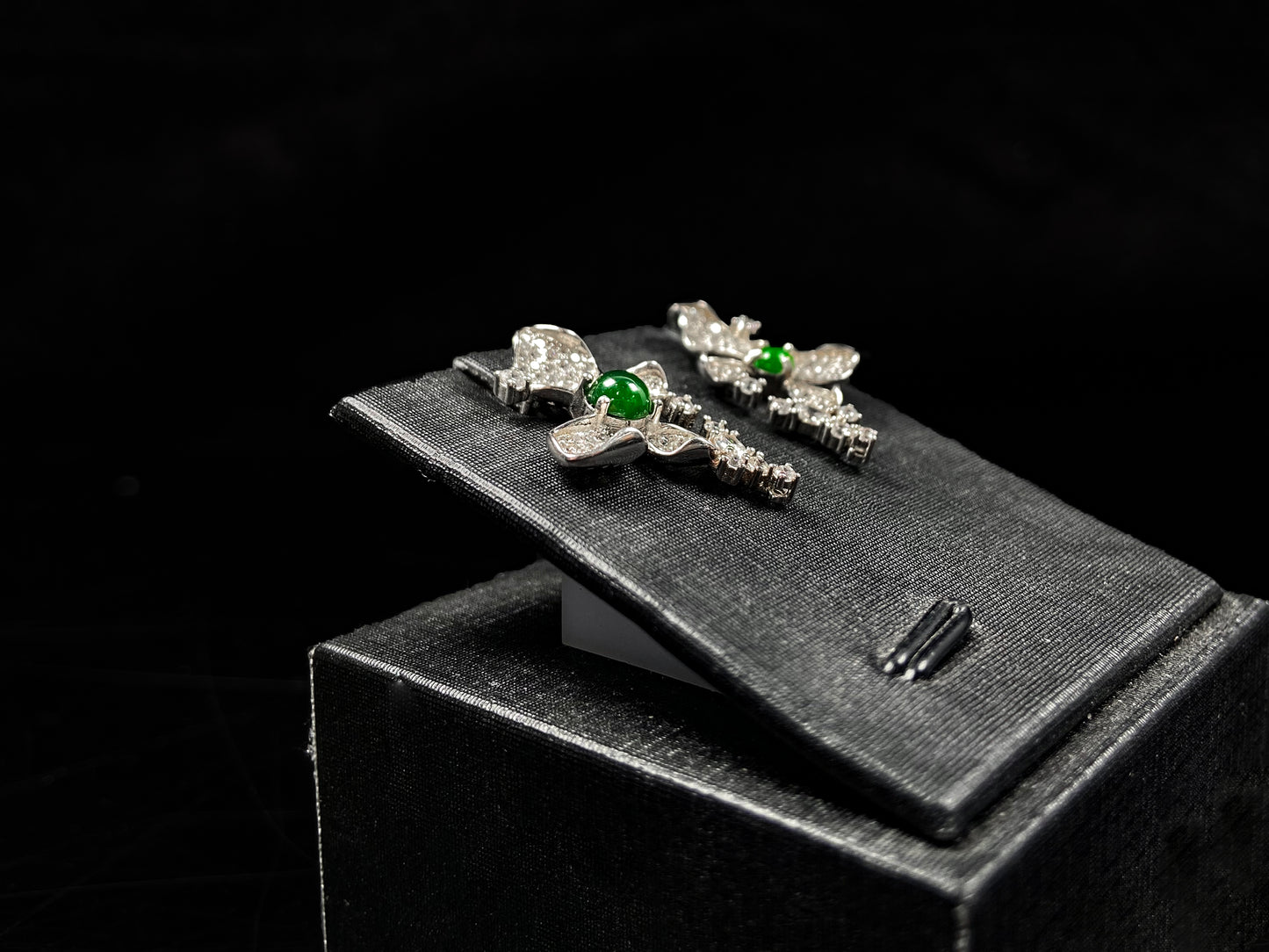 A pair of sparkling petal green core jadeite earrings.