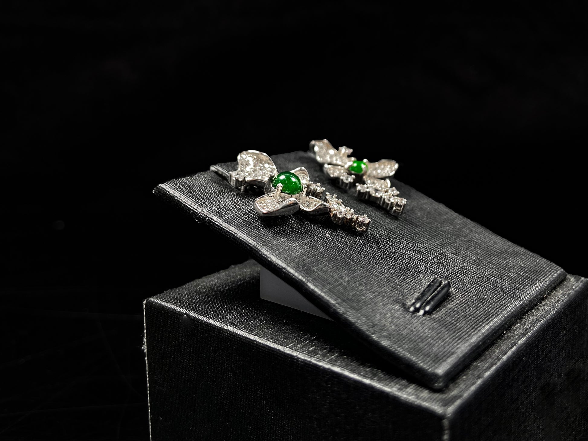 A pair of sparkling petal green core jadeite earrings.