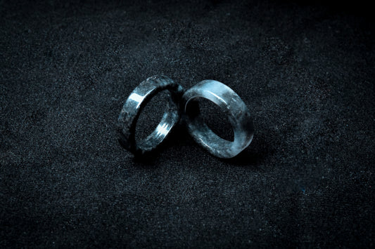 Two metallic rings on a dark textured surface