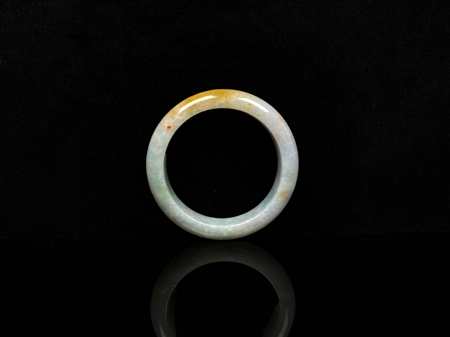 A creamy sunlit veil jadeite bangle.