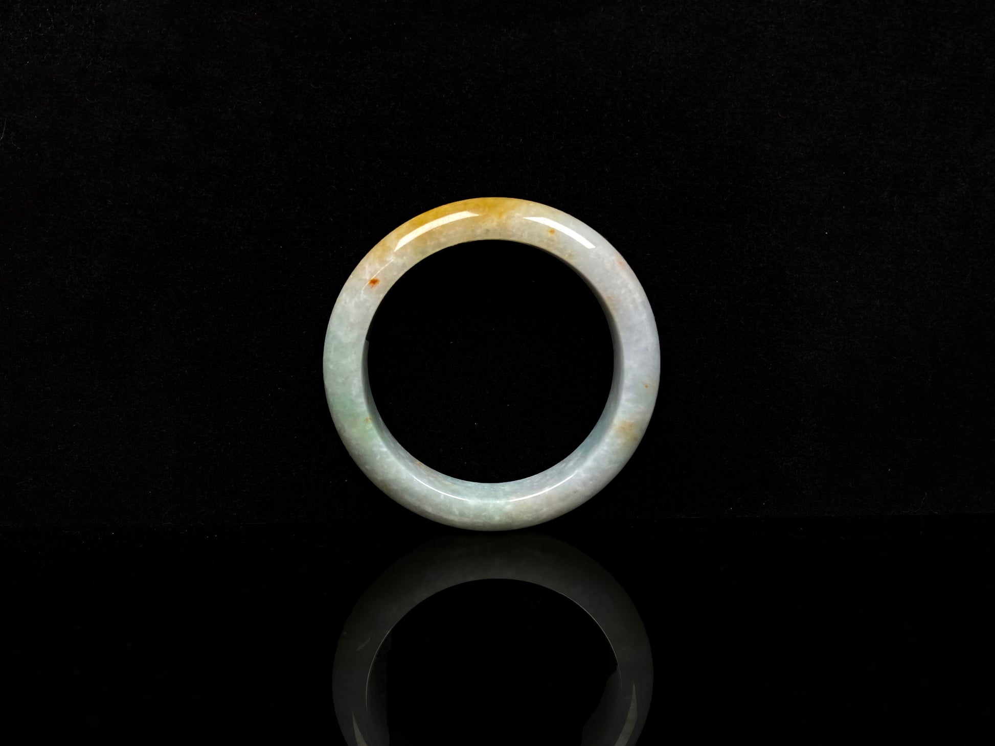 A creamy sunlit veil jadeite bangle.