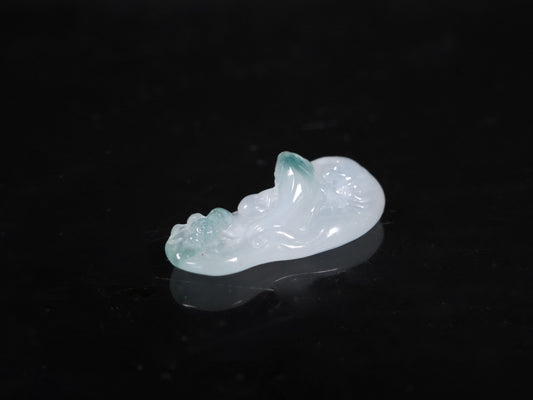 A icy base fish with blue accents loose jadeite.
