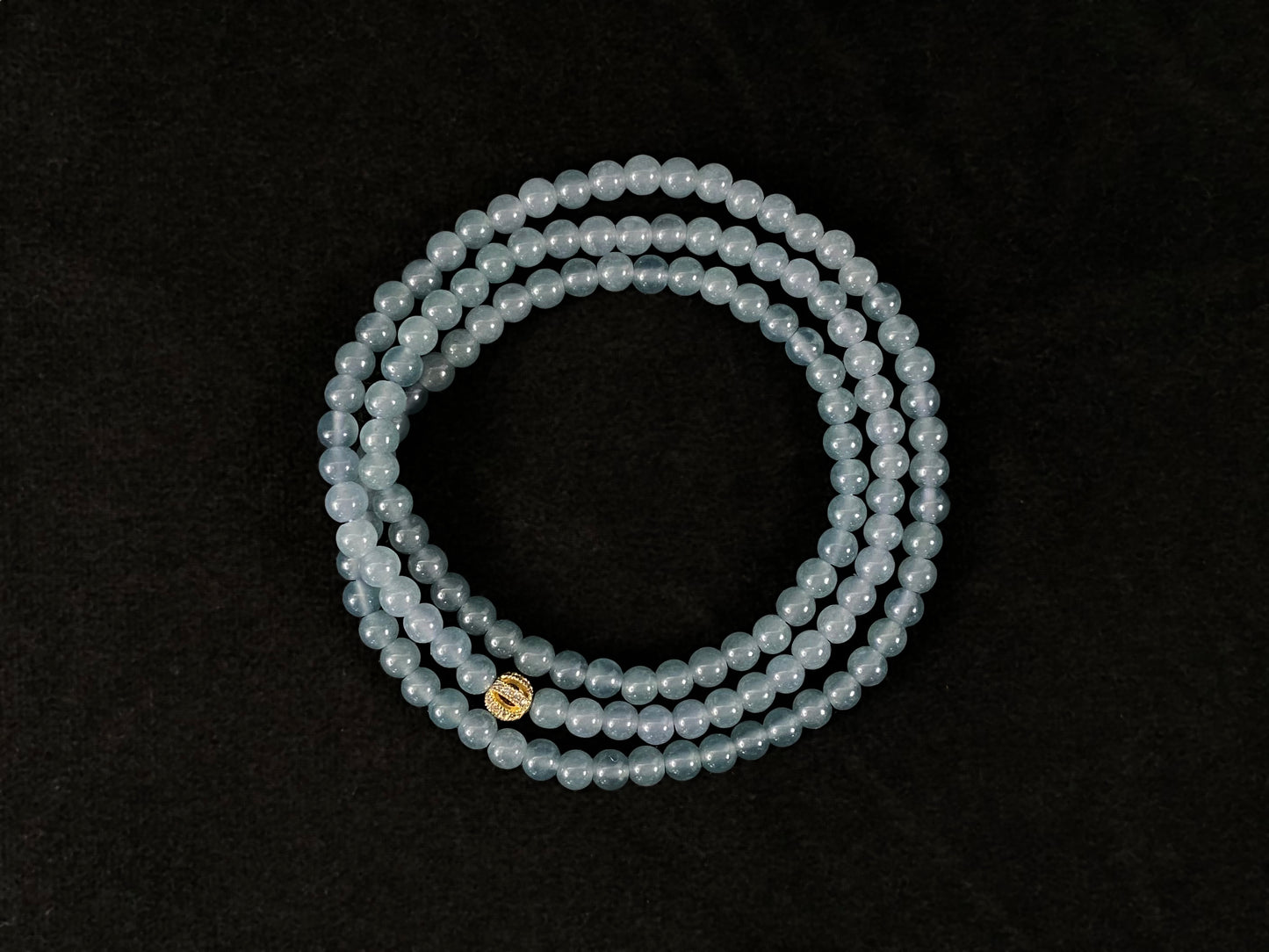 This jade bead strand features transparent blue beads.