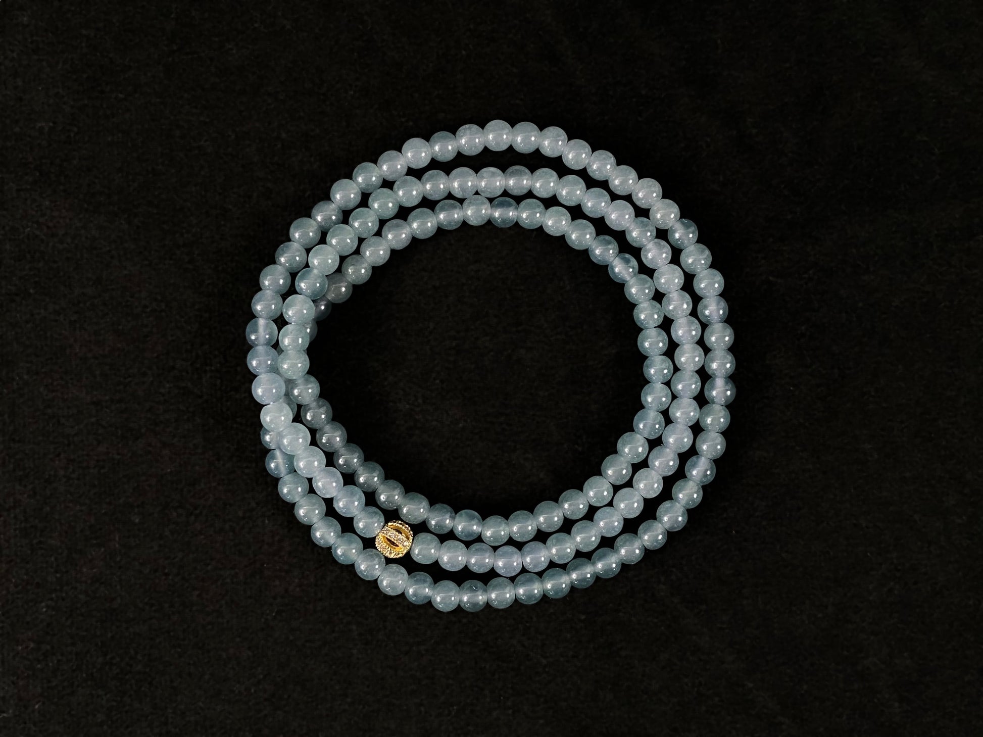 This jade bead strand features transparent blue beads.