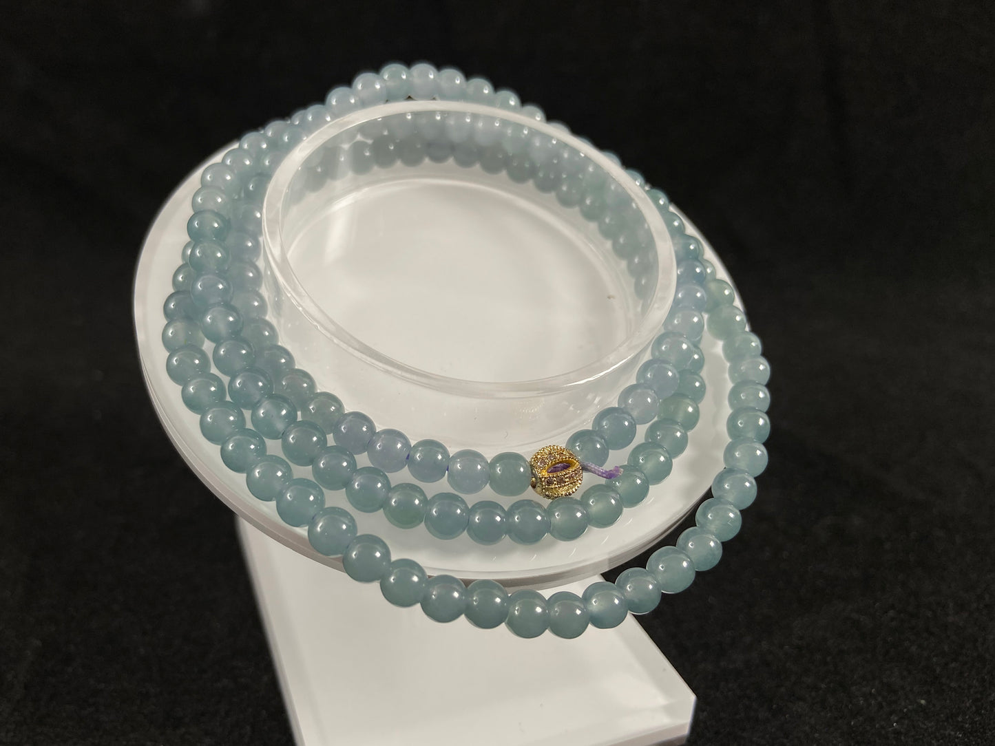 This jade bead strand features transparent blue beads.