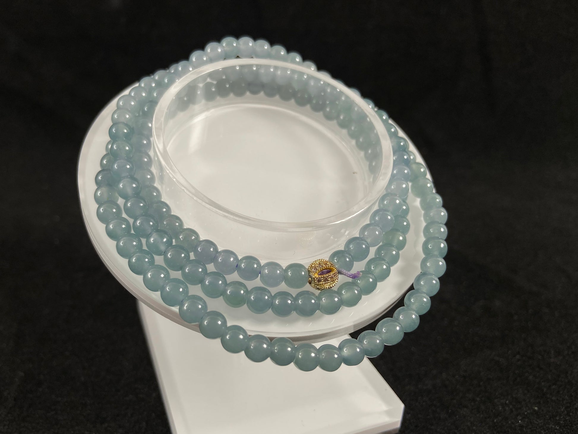 This jade bead strand features transparent blue beads.