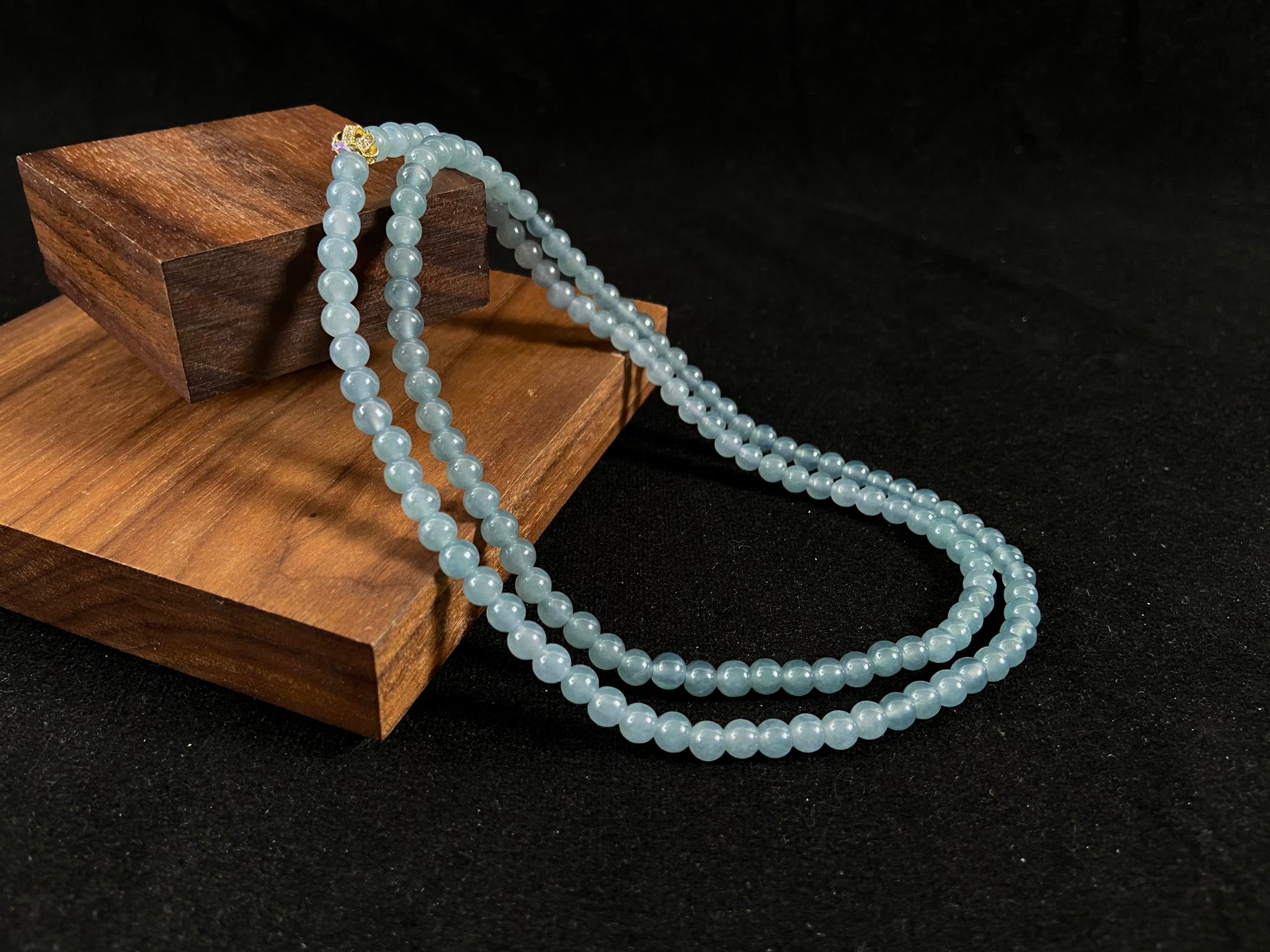 This jade bead strand features transparent blue beads.
