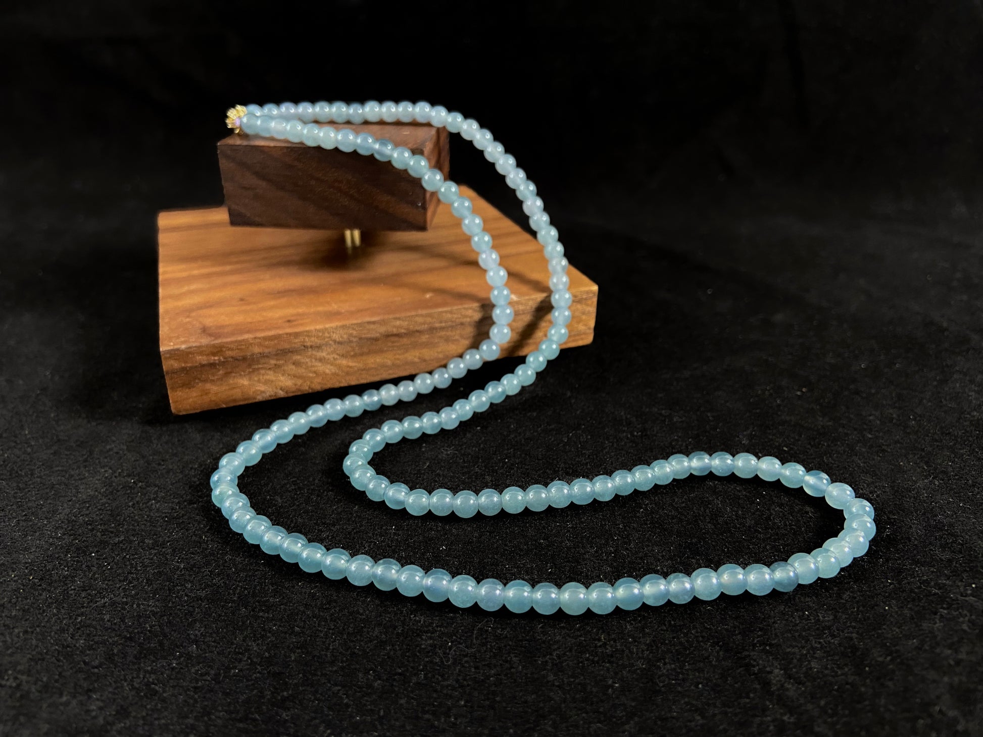 This jade bead strand features transparent blue beads.