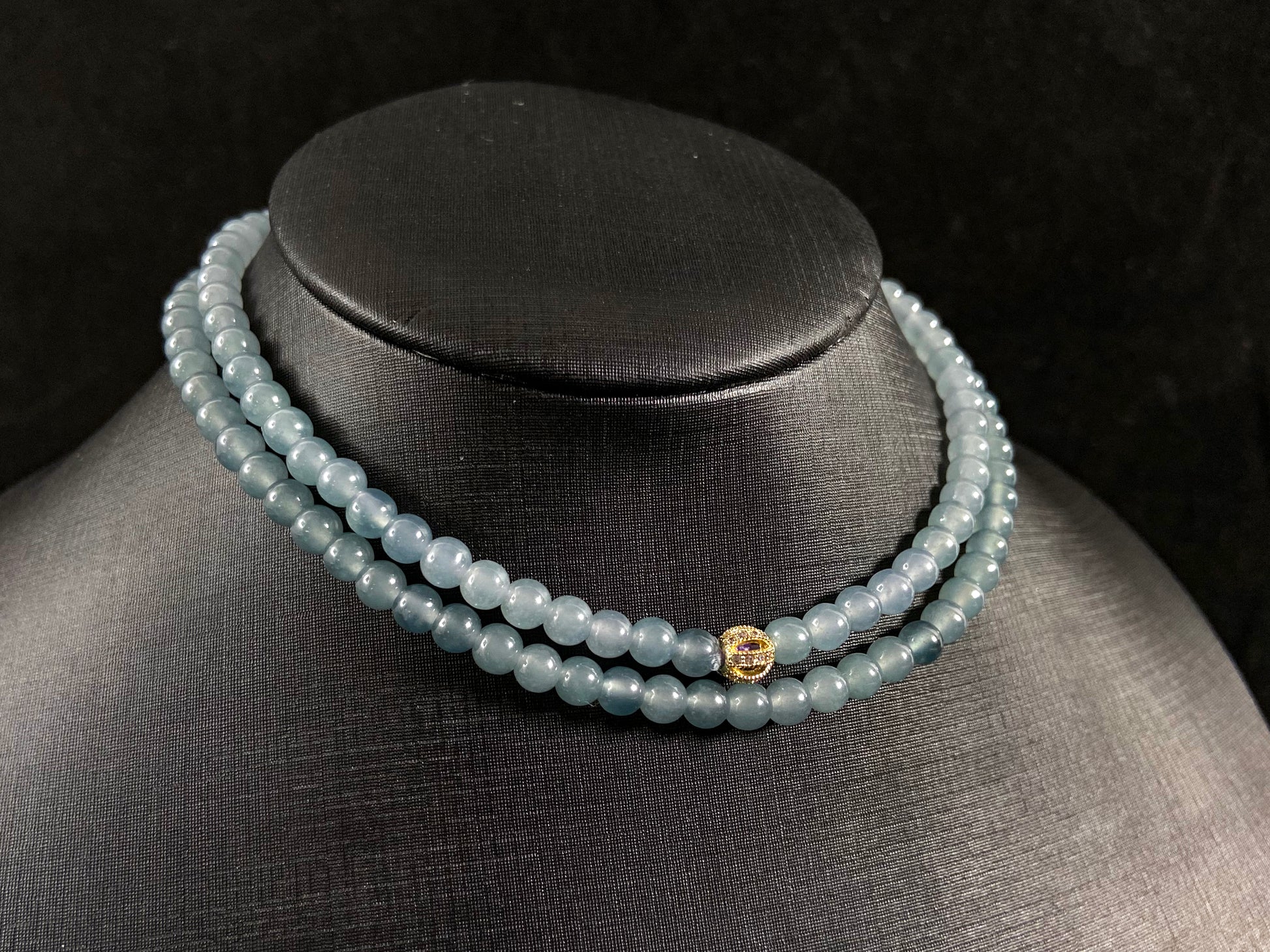This jade bead strand features transparent blue beads.
