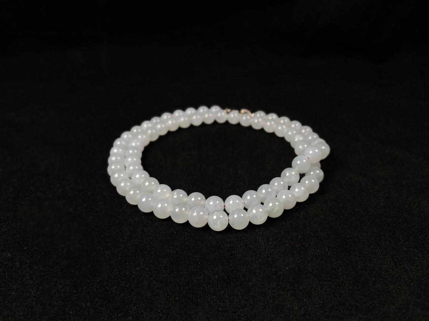 This elegant jadeite bead necklace features white semi-transparent beads.