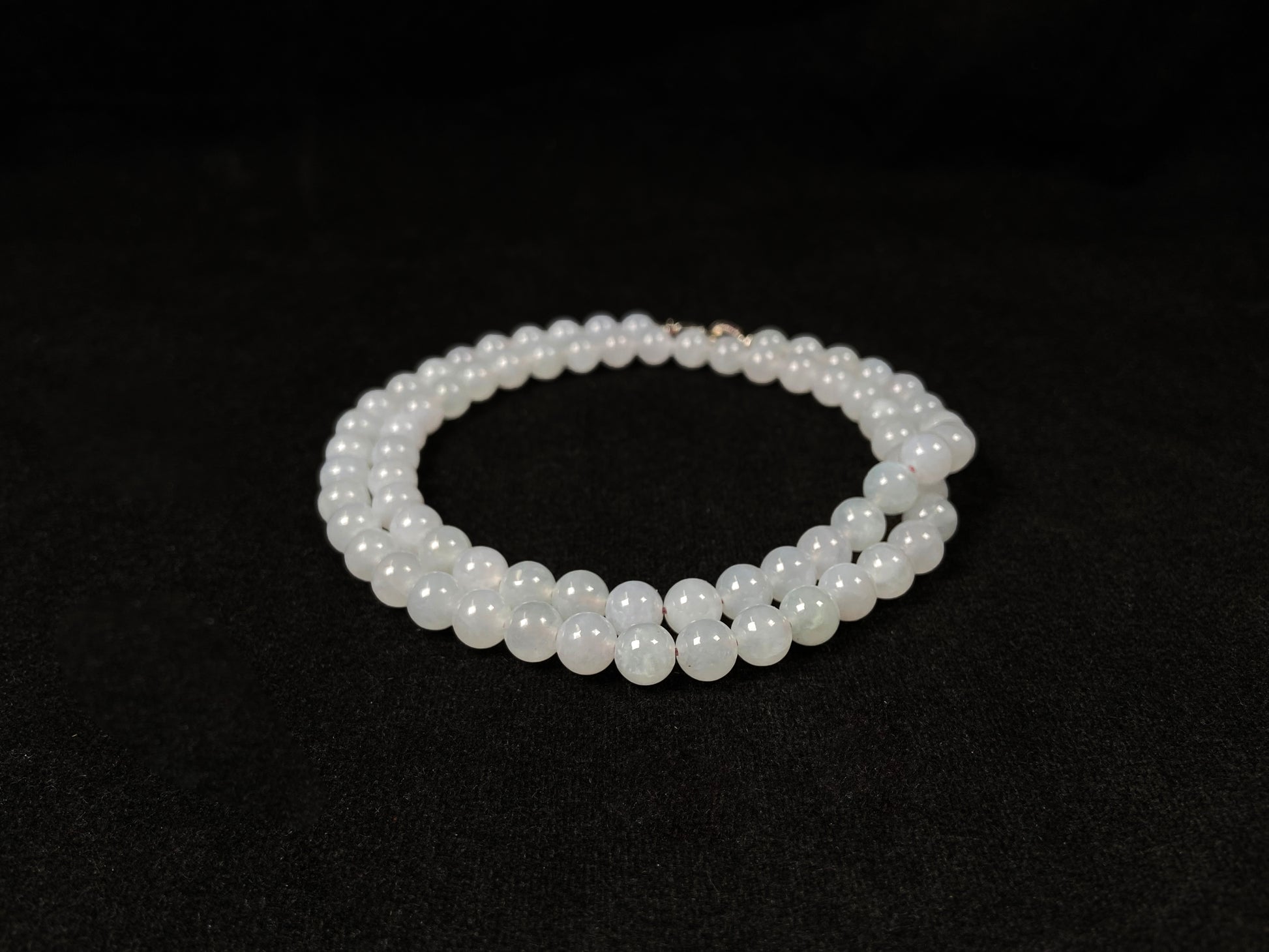 This elegant jadeite bead necklace features white semi-transparent beads.