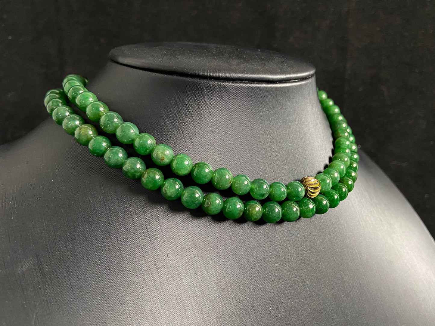 This elegant jade necklace combines spinach green beads with a silver gold plated focal bead, creating a perfect balance of natural beauty and metallic elegance.