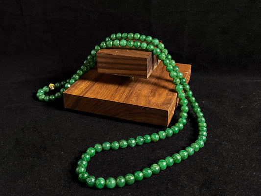 This elegant jade necklace combines spinach green beads with a silver gold plated focal bead, creating a perfect balance of natural beauty and metallic elegance.