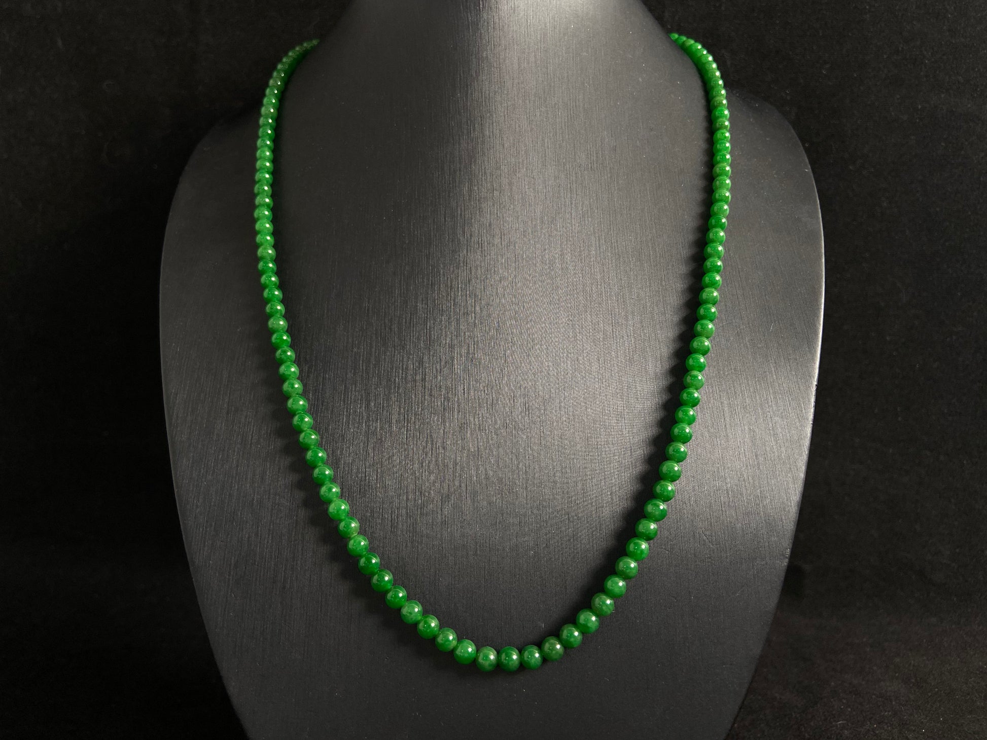 This necklace features imperial green jade beads of exceptional quality and vibrant color.