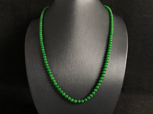 This necklace features imperial green jade beads of exceptional quality and vibrant color.