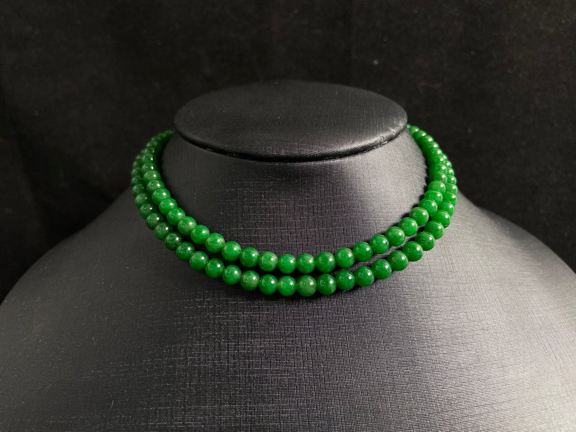 This necklace features imperial green jade beads of exceptional quality and vibrant color.