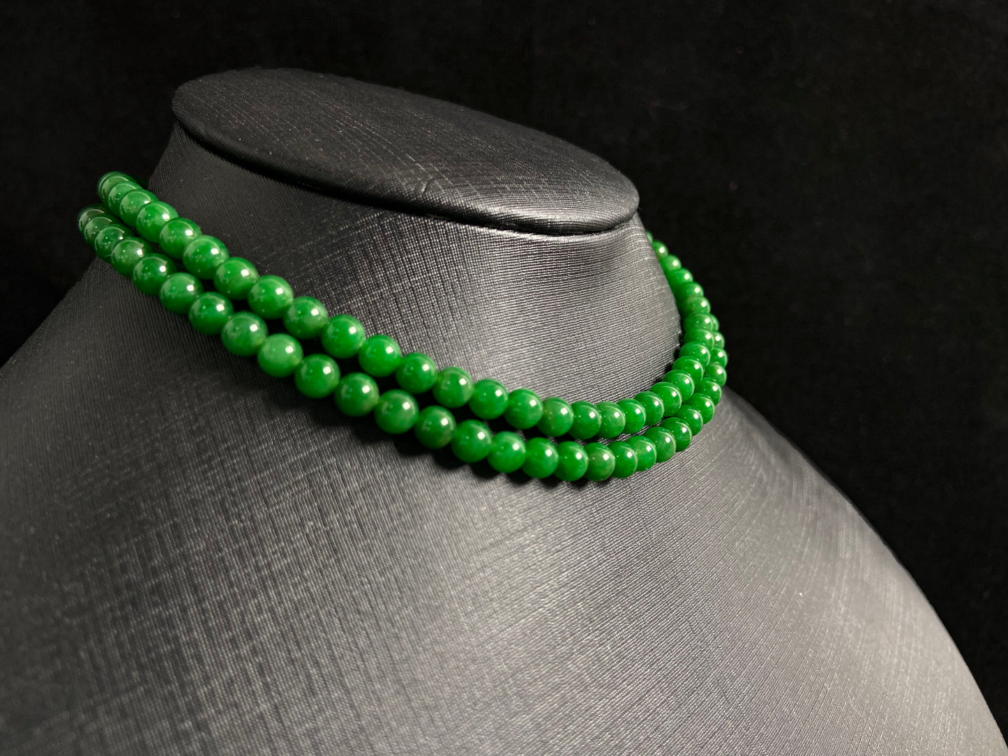 This necklace features imperial green jade beads of exceptional quality and vibrant color.