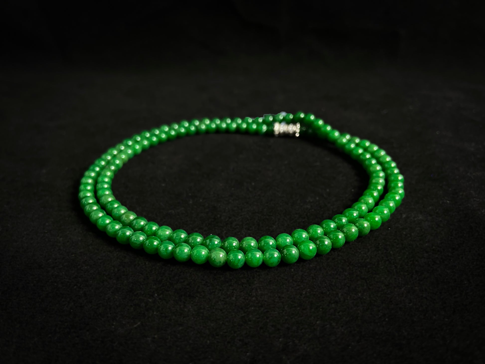 This necklace features imperial green jade beads of exceptional quality and vibrant color.