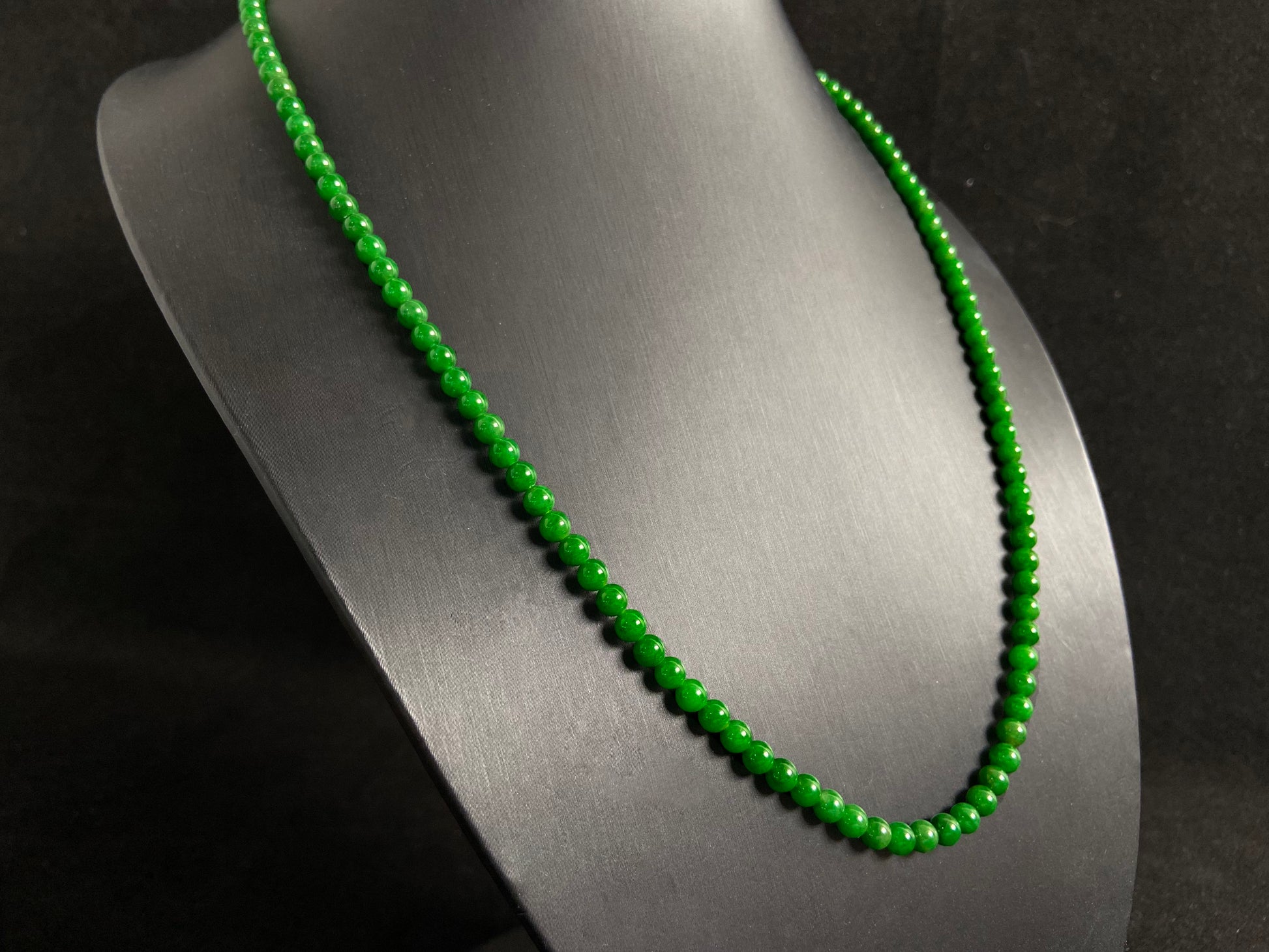 This necklace features imperial green jade beads of exceptional quality and vibrant color.