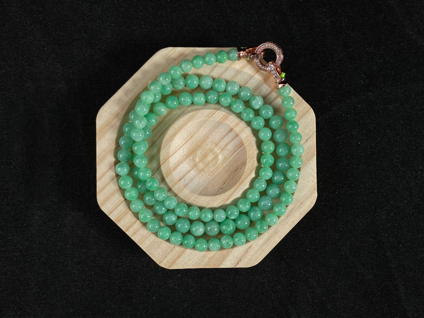 A jade bead strand composed entirely of small apple green beads.