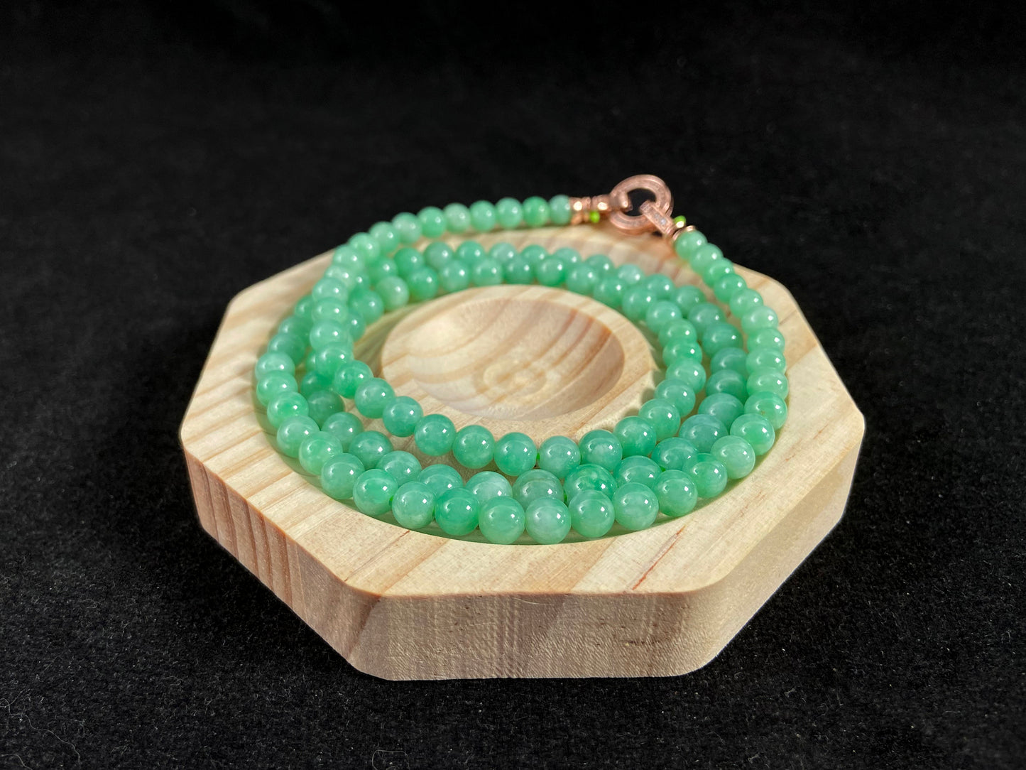 A jade bead strand composed entirely of small apple green beads.