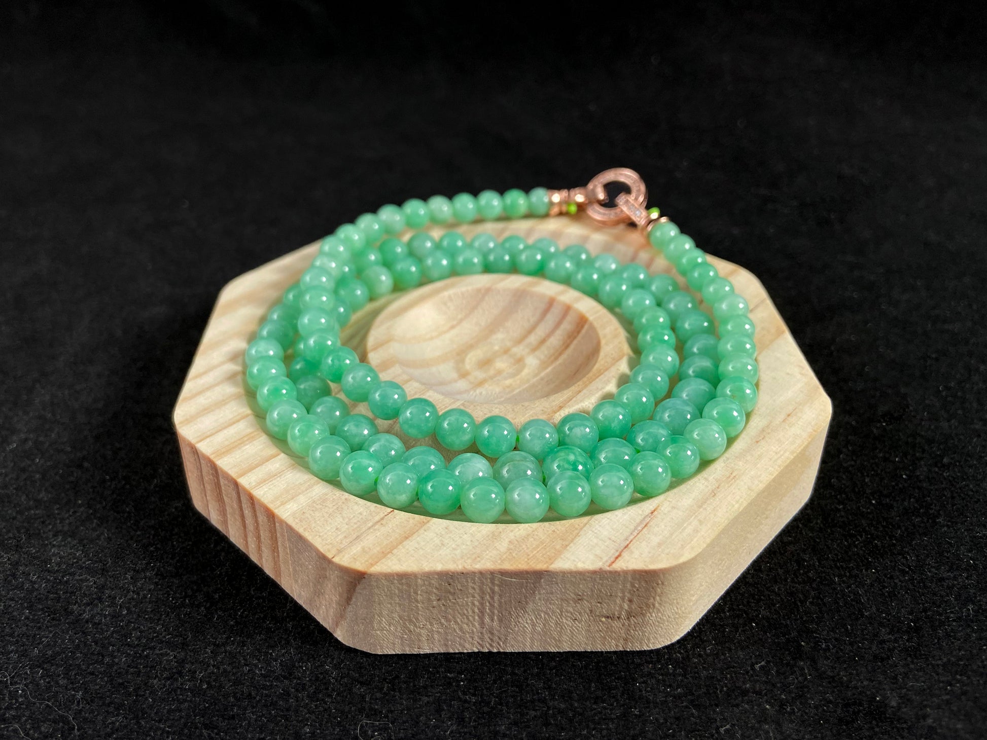 A jade bead strand composed entirely of small apple green beads.