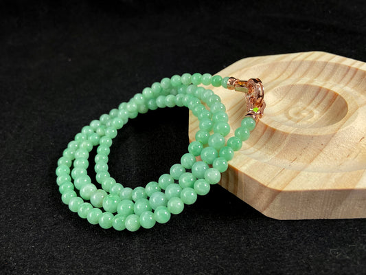 A jade bead strand composed entirely of small apple green beads.