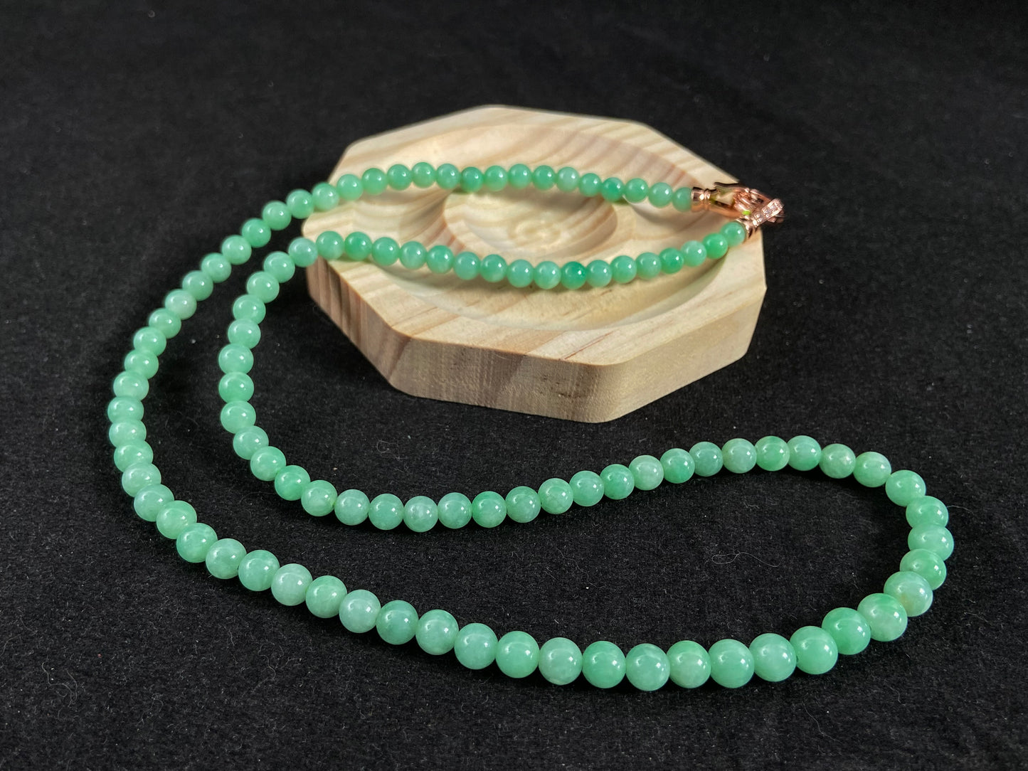 A jade bead strand composed entirely of small apple green beads.