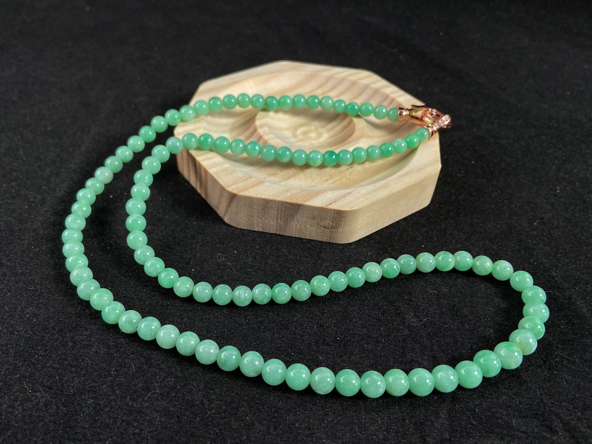 A jade bead strand composed entirely of small apple green beads.