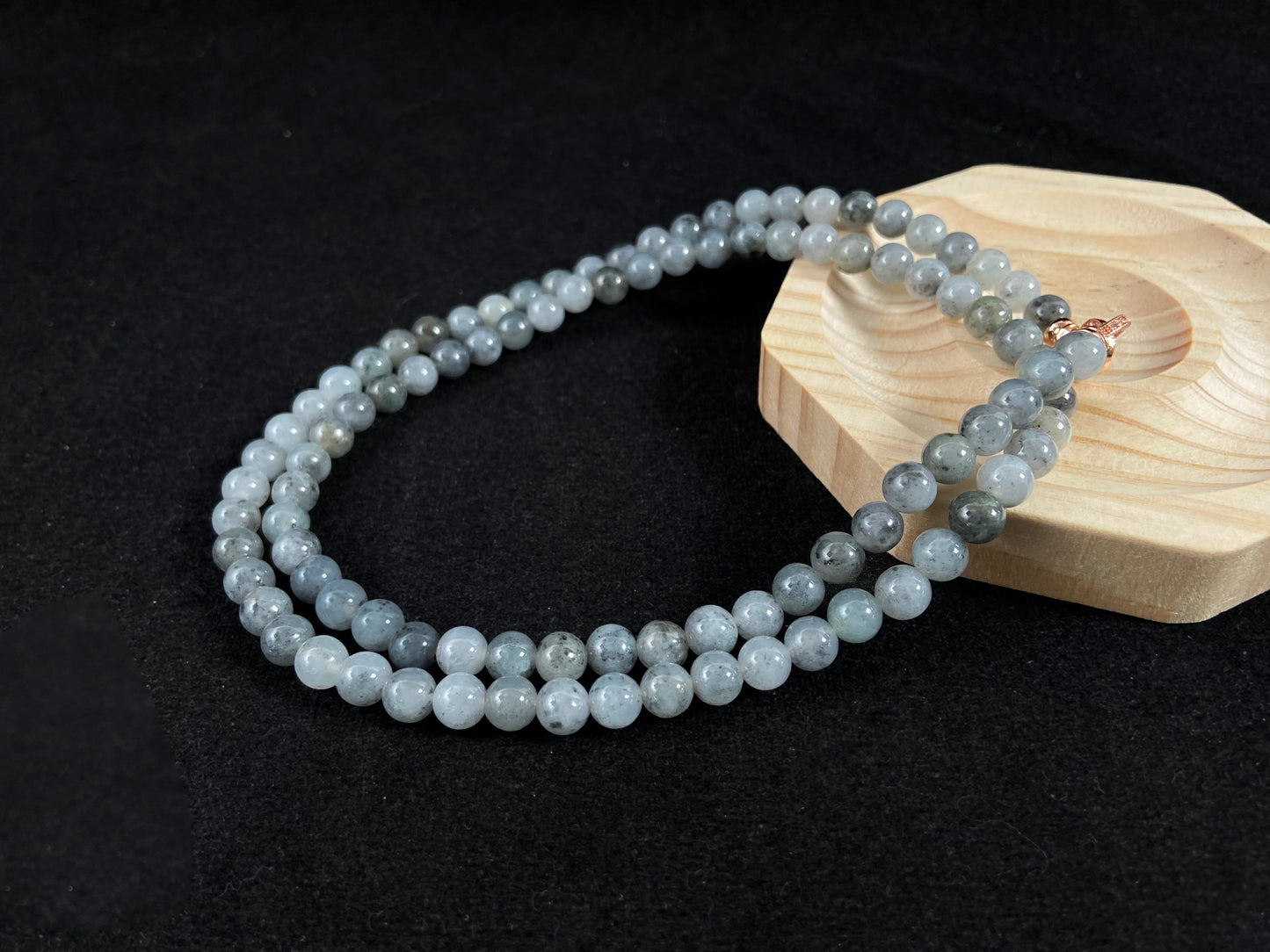 A jade bead strand composed of small pale gray beads.