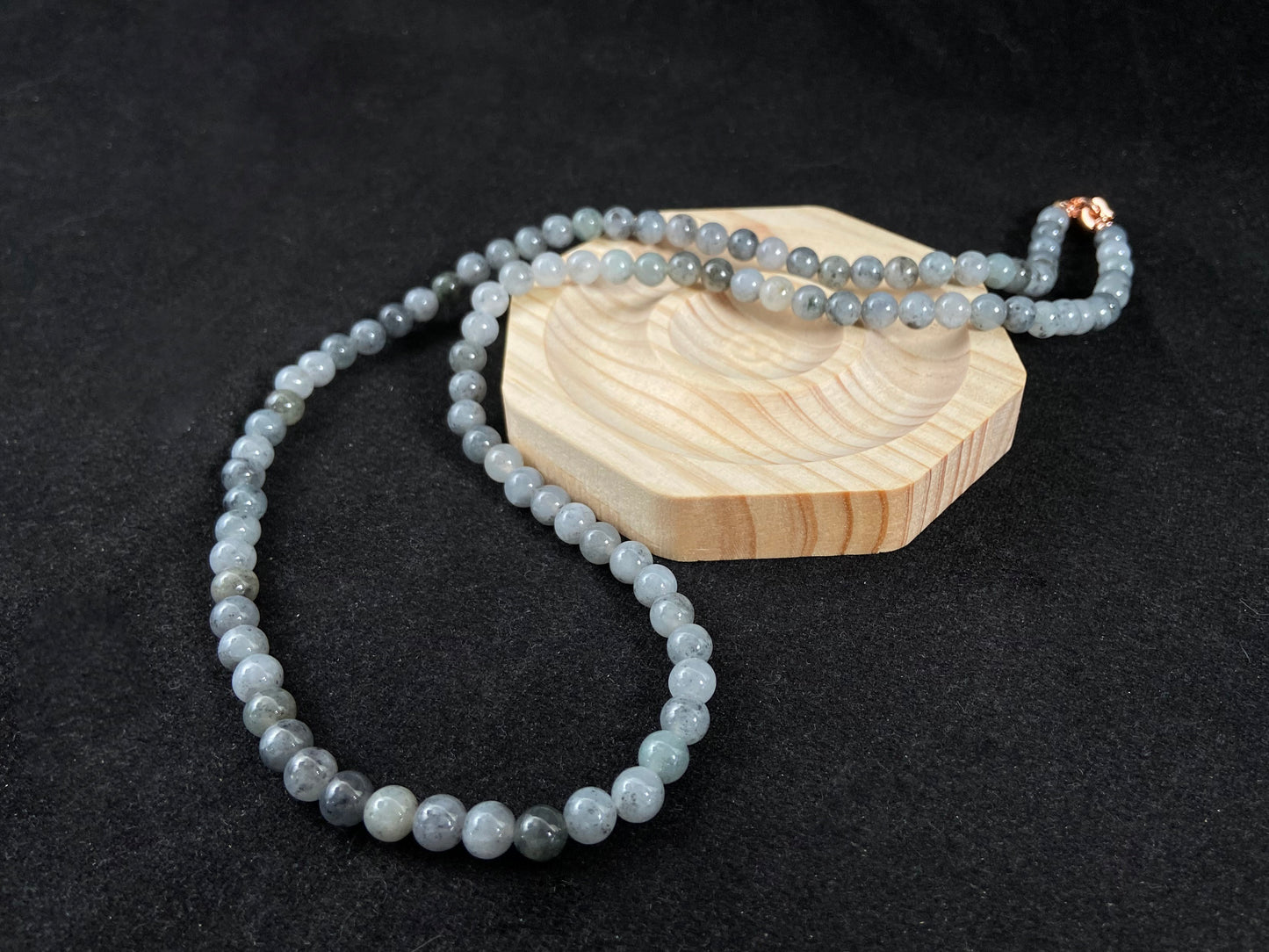 A jade bead strand composed of small pale gray beads.