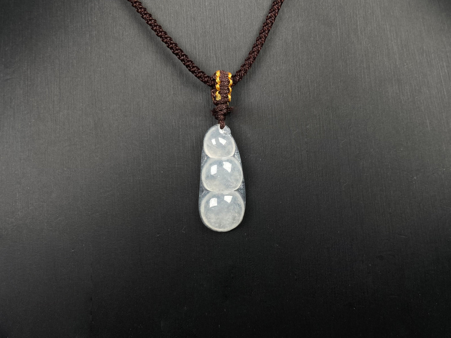 A pale green and icy white lucky pea pod jadeite pendant. 