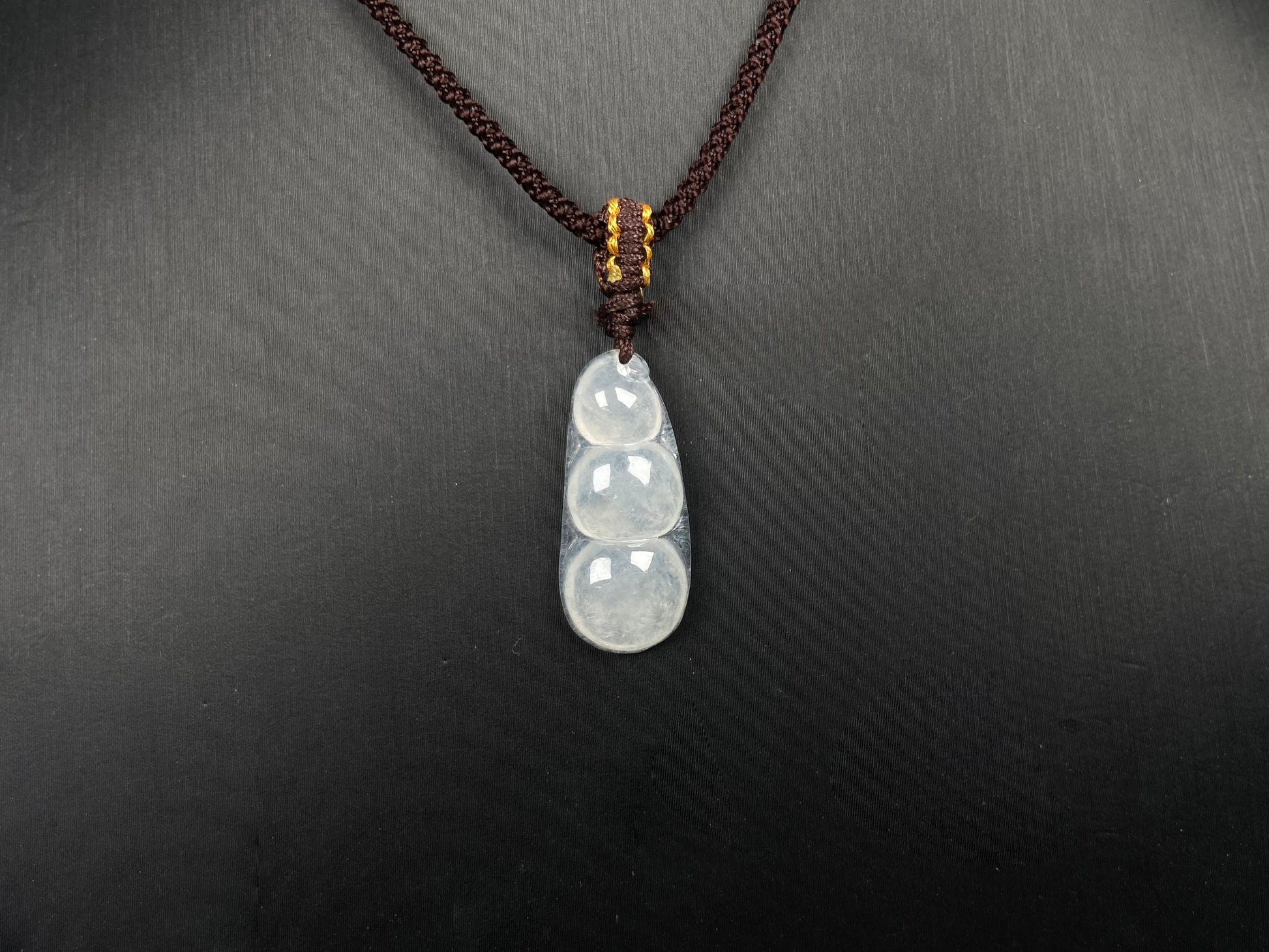 A pale green and icy white lucky pea pod jadeite pendant. 