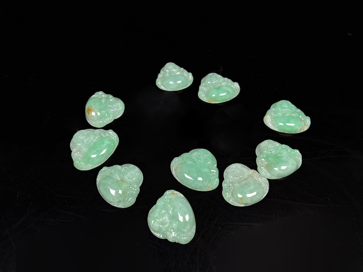 A apple green Maitreya Buddha loose jadeite group.