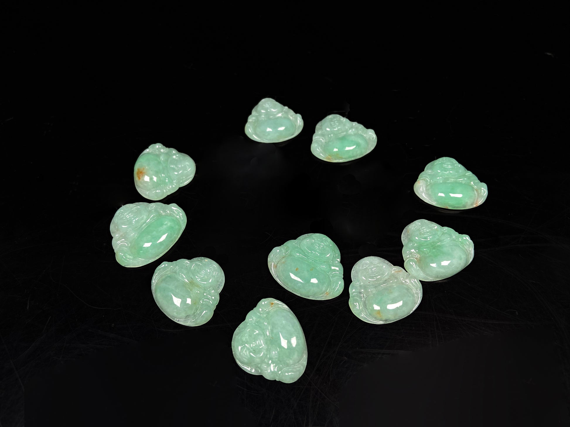 A apple green Maitreya Buddha loose jadeite group.