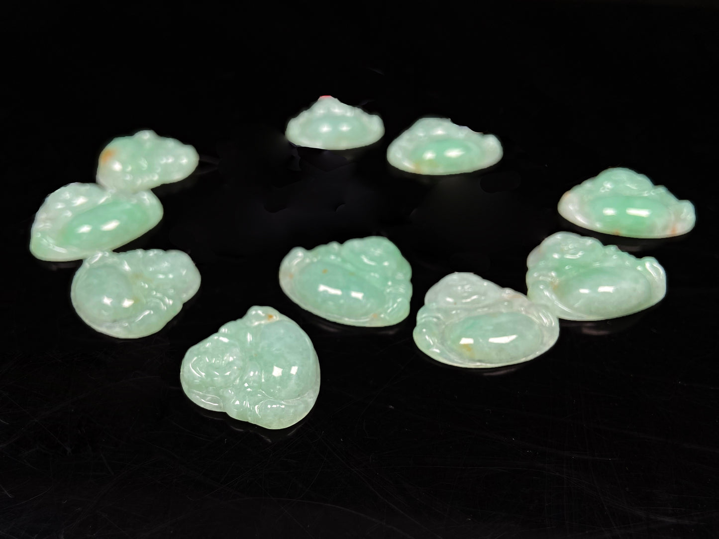 A apple green Maitreya Buddha loose jadeite group.