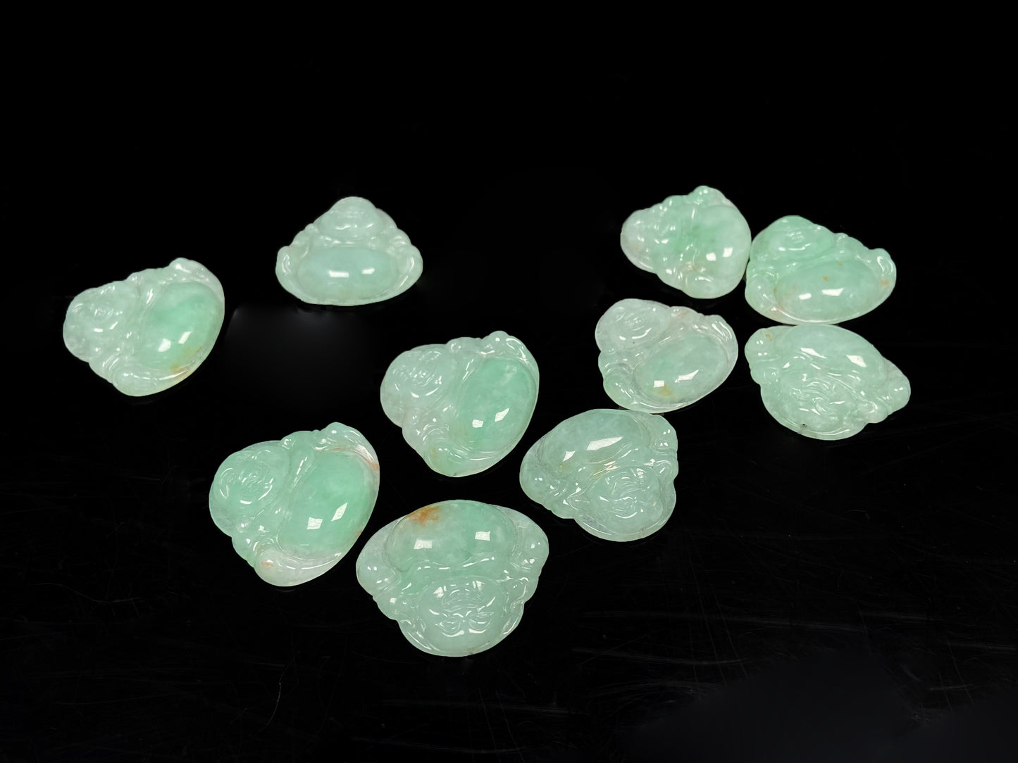 A apple green Maitreya Buddha loose jadeite group.