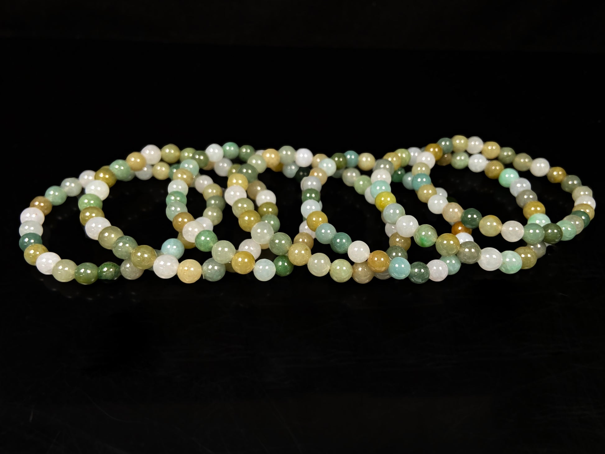 A pastel green mix jadeite beads bracelet group.