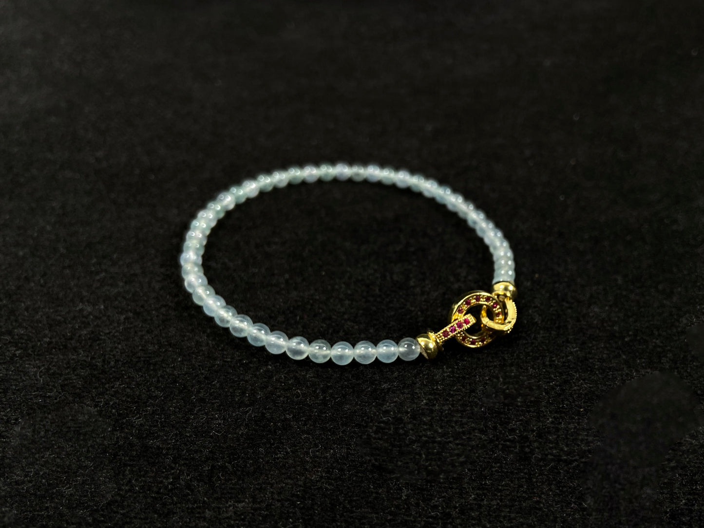 An icy jade bead bracelet with a golden clasp.
