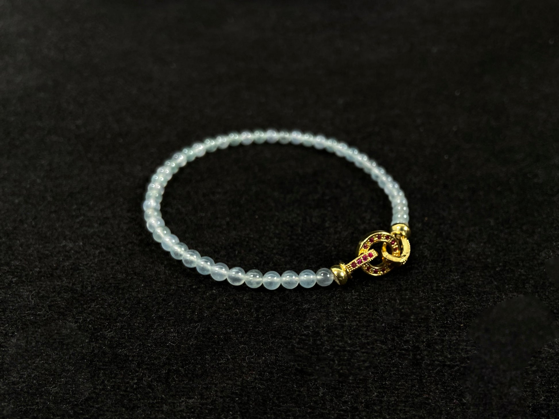 An icy jade bead bracelet with a golden clasp.