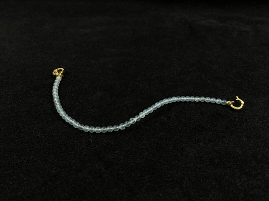 An icy jade bead bracelet with a golden clasp.